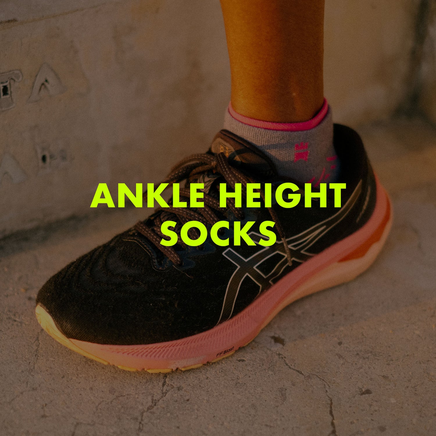 Photograph of an athlete wearing a pair of trainers and ankle height socks with text overlay saying "Ankle Height Socks".