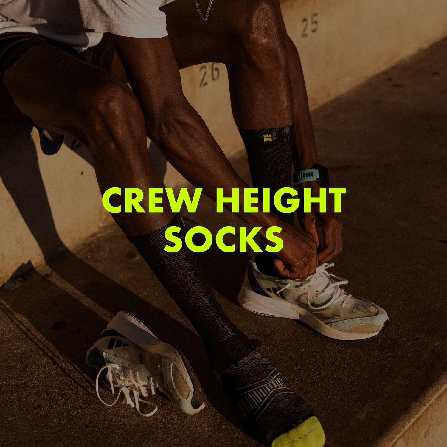 Photograph of an athlete putting on a pair of crew height socks with text overlay saying "Crew Height Socks".